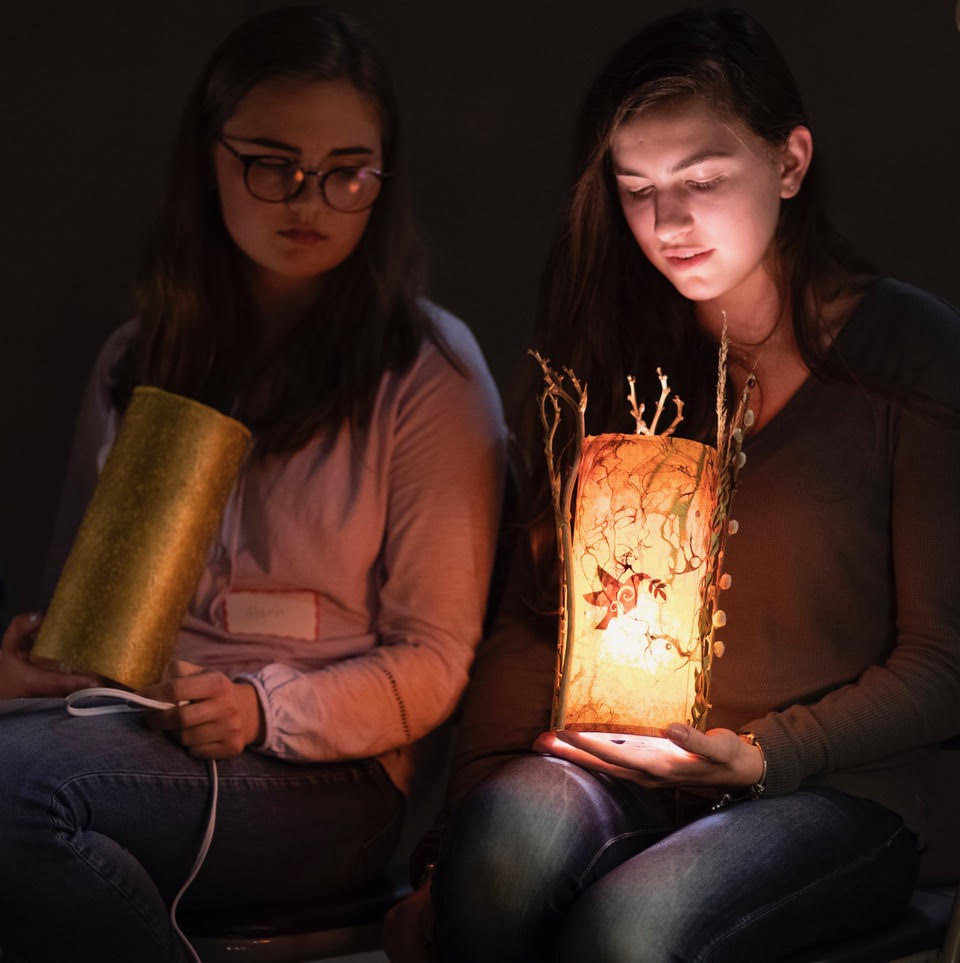 two girls holding orlanu lights